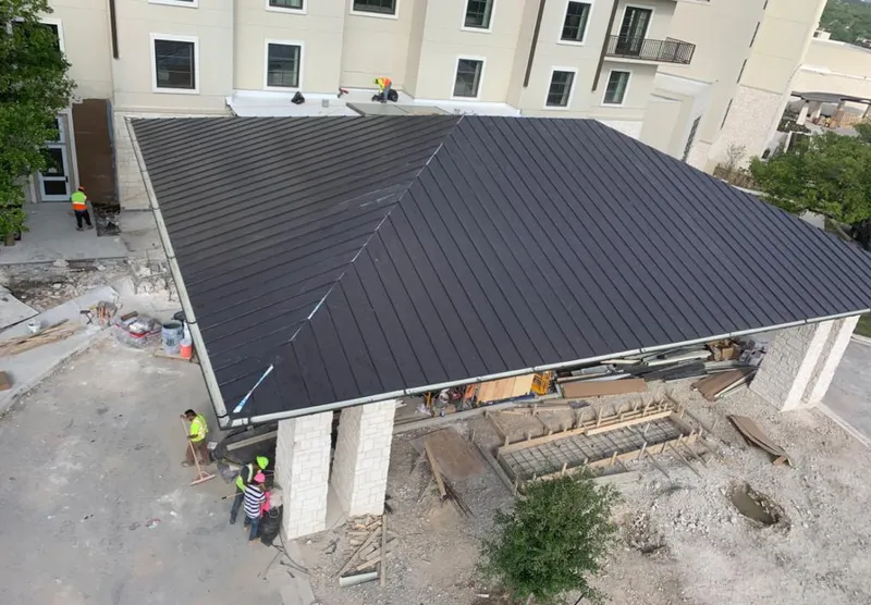 Metal roofing installation team working on a commercial building in Hempfield